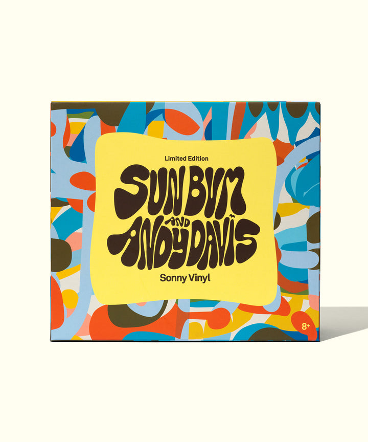 Colorful limited edition Sonny Vinyl packaging featuring psychedelic design with Sun Bum and Andy Davis collaboration logo on vibrant yellow background, surrounded by abstract blue, orange, and brown shapes. Sun Bum