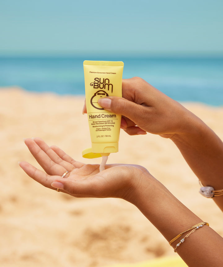 Applying Original SPF 15 Sunscreen Hand Cream on the beach, Sun Bum